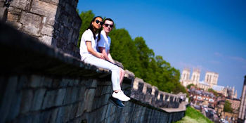 Students sat on walls, Minster in background